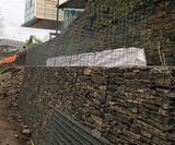 Gabion baskets support existing stone wall at university - on this page