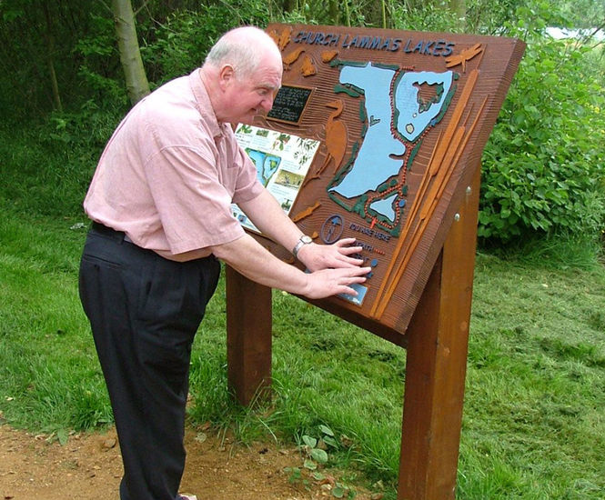 Tactile sand-blasted timber signs with graphics
