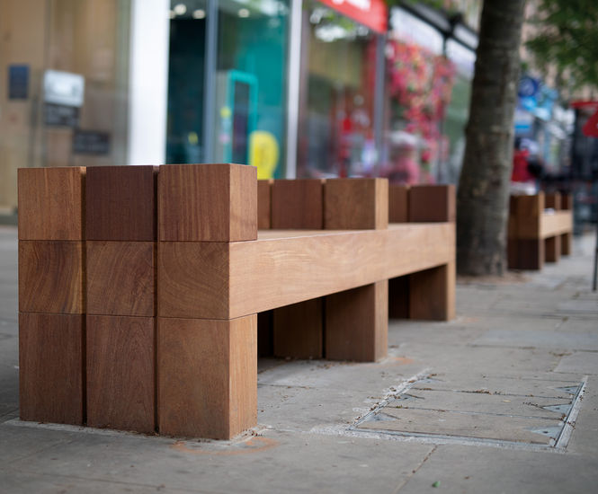 Beam timber benches line Kensington High Street