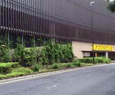 Bronze cladding and mesh fencing - supermarket car park