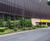Bronze cladding and mesh fencing - supermarket car park 0