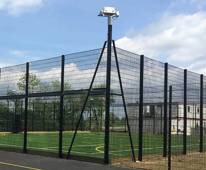 Integrated floodlight posts for sports fencing