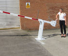 Manually operated rising arm traffic control barriers