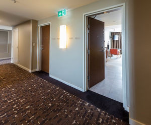 Door protection with faux wood finish for hotel