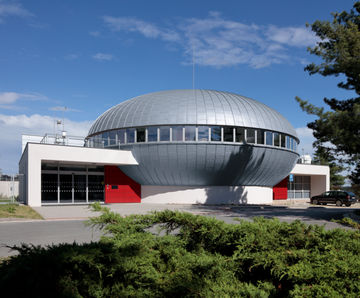 Zinc seamed cladding covers circular planetarium roof
