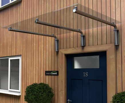 Type M glass door canopy with tubular brackets