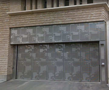 Bespoke folding doors with vehicle motif secure Dutch mall