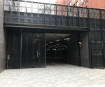 Electrically-operated multi-fold gates for service bay