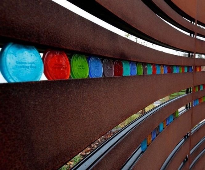 Corten steel and coloured glass screen mining memorial
