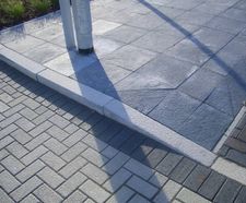 Silver grey granite dropper kerb for road access transitions