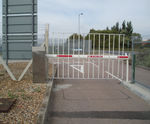 Automatic rising arm security barrier with full-height swivel skirt