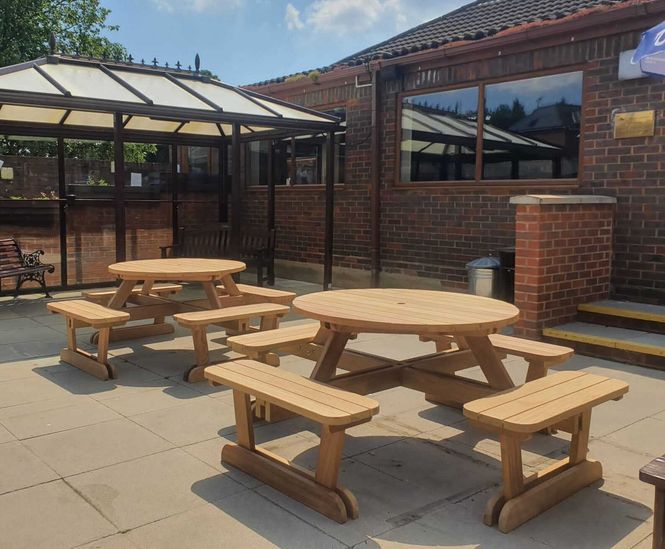 Round iroko 8-seater picnic table and benches