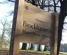 Bespoke carved oak signage scheme at Brockhampton Estate